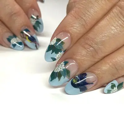 Blue-tipped almond-shaped nails with hydrangeas and birds