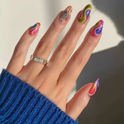 Shimmery multicolored swirl nails with a disco ball accent nail