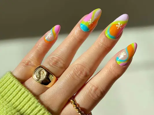 Manicure in swirling shades of lavender, orange, green, and blue