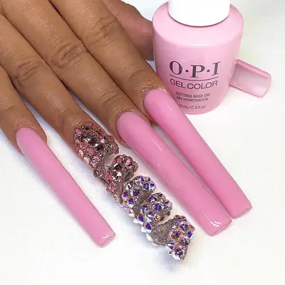 Close up of Cardi B, her hand in front of her face with a dramatic manicure