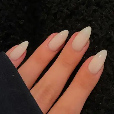 close up of milky white almond shaped nails