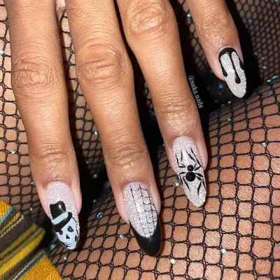 a sparkly silver manicure with black accents