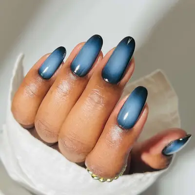 a deep ombre manicure with black and blue 