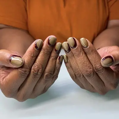 beige nails with a brown-burgundy base 