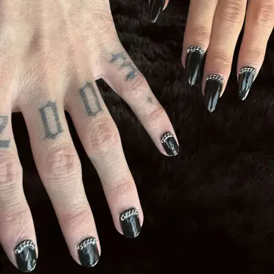 black nails with chains at base