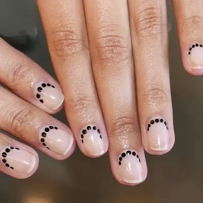 clear nails with black dots at base
