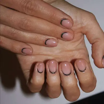 clear nails with a shimmery black line at the base