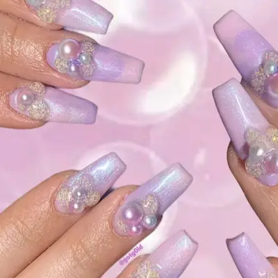 purple nails with pearls at the base