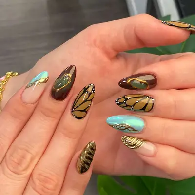 Butterfly and teal blue accent brown manicure