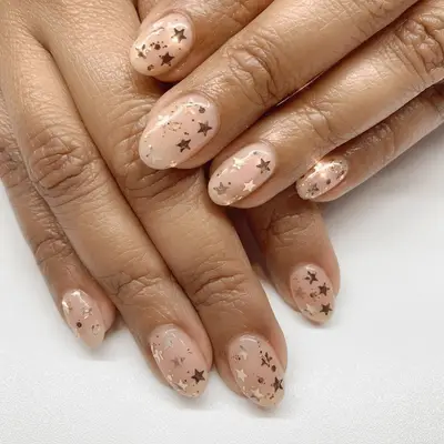 Long square-shaped black ombre manicure with gold star and moon decals