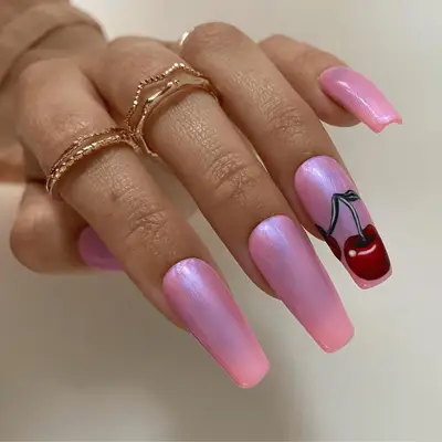 Close up of pink chrome nails with a graphic art-style cherry accent nail art.