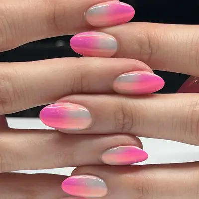 Manicure with pink and white chrome French tips and heart gem accents