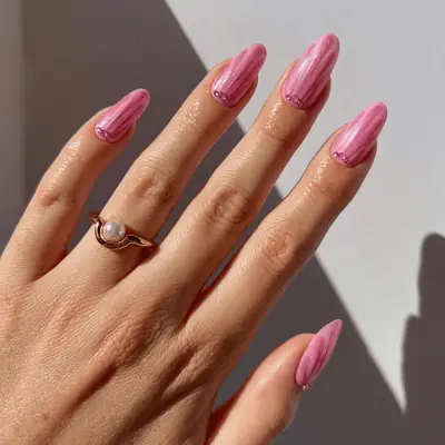 Close up of pink nails with fuschia chrome seashell detailing.