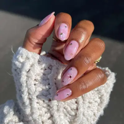 Pink nails with white dusting and diamond accents