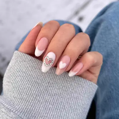 Diamond accented heart nail art with pink and white tones