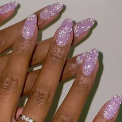 Lavendar nails with shimmering pink and silver designs