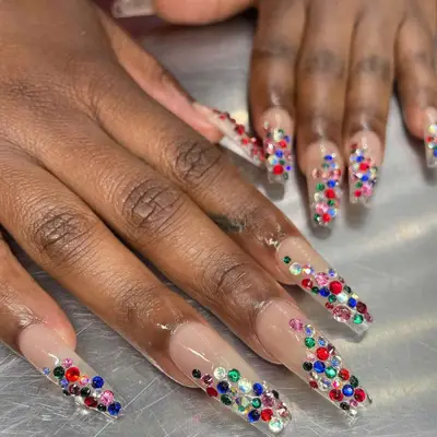 Neutral manicure with multicolored rhinestones on tips