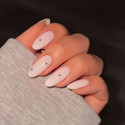 Minimalist cream nails with rhinestone accents
