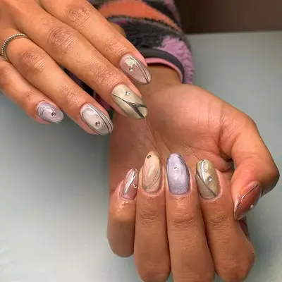 Mismatched nails in jewel tones with diamond accents