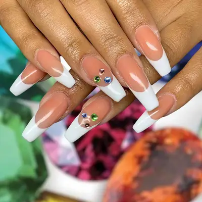 French tip nails with three colored diamond accent nails