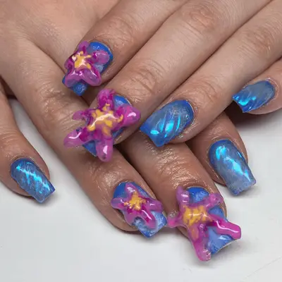 Close up of blue sheen nails with purple and yellow 3D blob starfish.