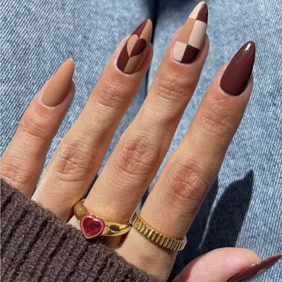 Close up of a mismatched manicure in shades of brown