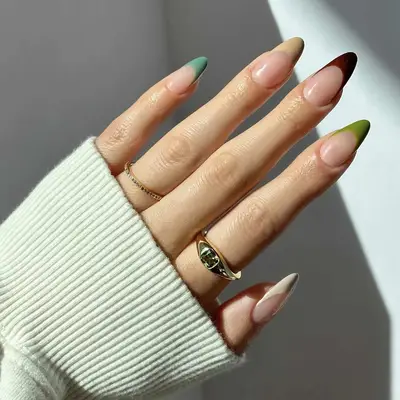 Close up of a French manicure in shades of brown and green