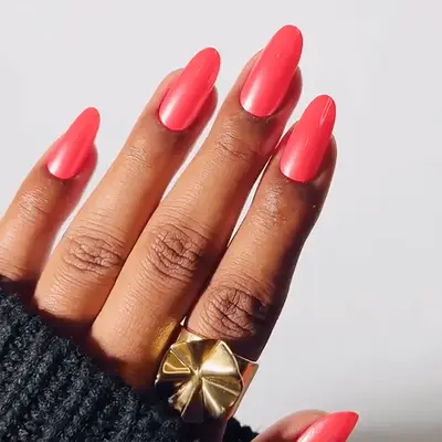 Close up of a French manicure with teal tips and one white accent nail