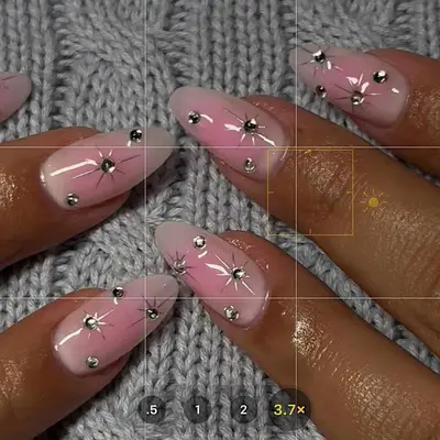 a pink aura manicure with diamond rhinestone accents