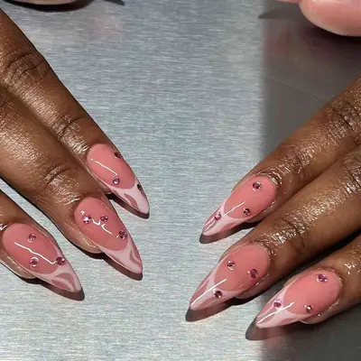 a pink french manicure with with pink diamond rhinestone accents