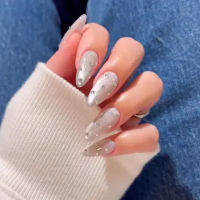 a silvery velvet manicure with diamond rhinestone accents