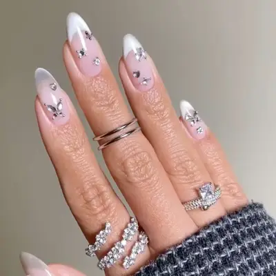 a velvet glass french manicure with diamond rhinestone accents
