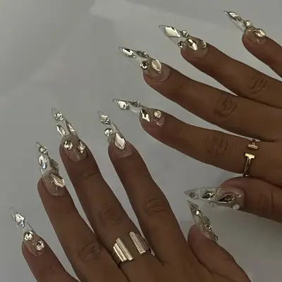 long clear nails topped with chunky rhinestones