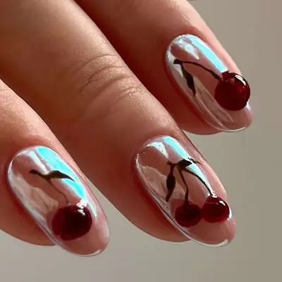Chrome nail art featuring cherries on each nail