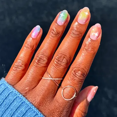 rainbow aura nails with white sparkle designs 