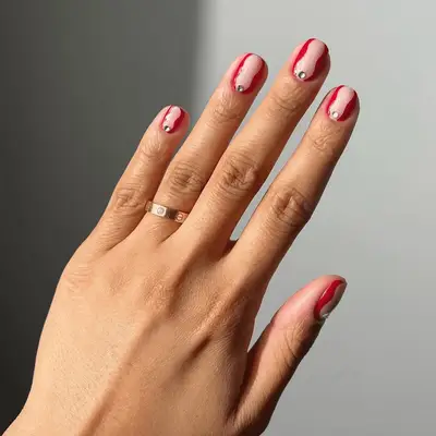 short red nails with negative space and gemstones