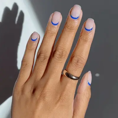 nude nails with blue cuticle design