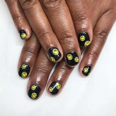 black and yellow smiley face nails 