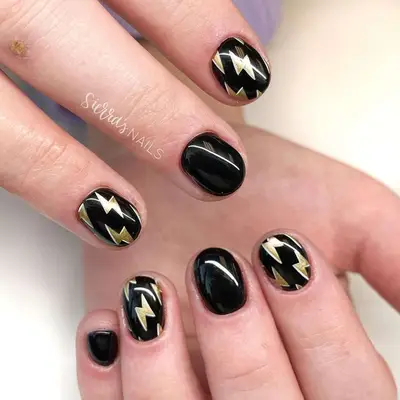 Gold Lightning Bolt nails with black polish 