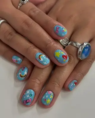 A cloudy, cyan blue manicure