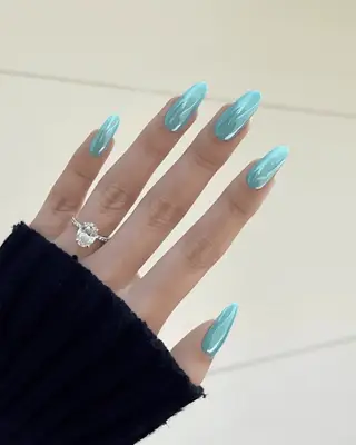 an mismatched blue and purple manicure with two turquoise nails