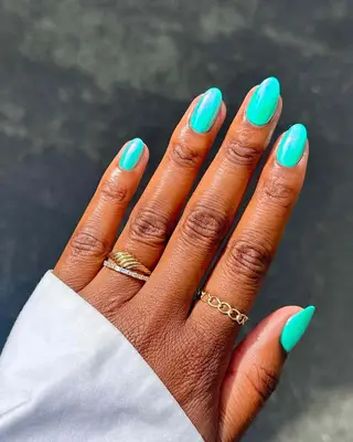 a turquoise chrome manicure