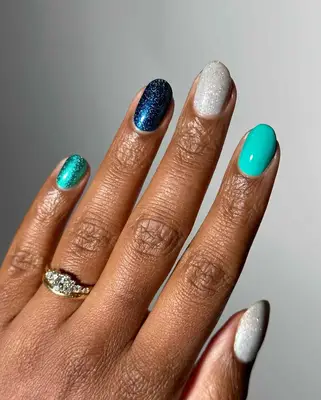 a skittle manicure in glittery cool shades