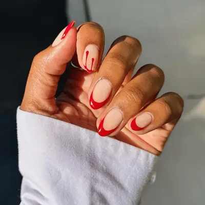 Red French manicure with drippy detail