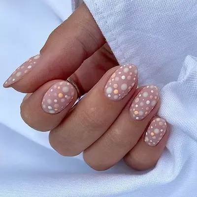 Neutral manicure with multicolored dots