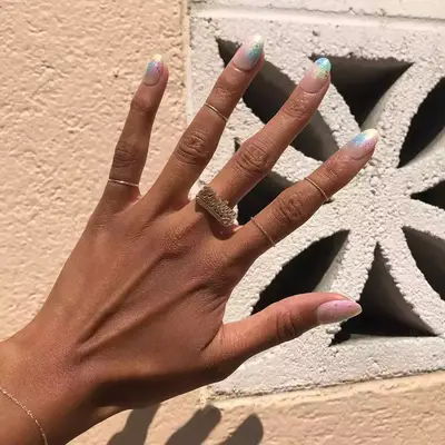 Manicure with neutral base and rainbow iridescent ombre tips