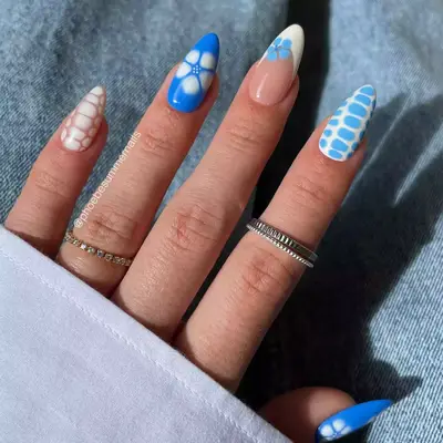 Close up of blue nails with pool pattern print art and faded hibiscuses.