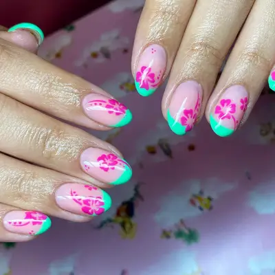 Close up of green French tips with orchid purple hibiscus nail art.