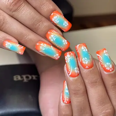 A yellow French manicure with hibiscus accents in pink and orange