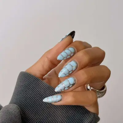 Silver and baby blue crocodile print nails.